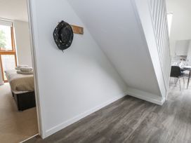 A bedroom with a bed and a hat on a rack at Everdene Upwey near Weymouth