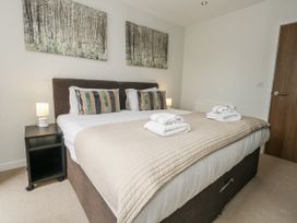 A bedroom with a double bed and bedside table at Everdene near Weymouth