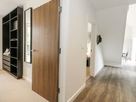A hallway with a door and a shelf at Everdene in Upwey near Weymouth