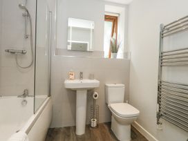A bathroom with a shower, bathtub, sink and toilet at Everdene in Upwey near Weymouth