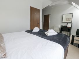 A bedroom with a bed and desk at Everdene in Upwey near Weymouth