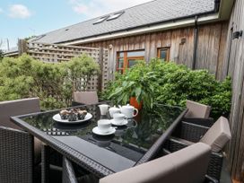 An outdoor dining area with a table and chairs at Everdene Upwey near Weymouth