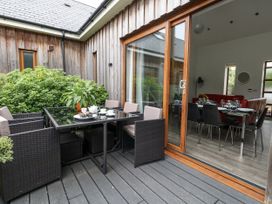 An outdoor dining area with a table and chairs at Everdene in Upwey near Weymouth