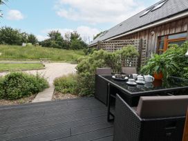 An outdoor seating area with a table and chairs at Everdene in Upwey near Weymouth
