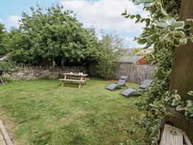 A garden with a picnic table and deck chairs at Everdene Upwey near Weymouth