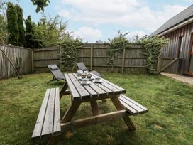 A garden with a picnic table and chairs at Everdene in Upwey near Weymouth