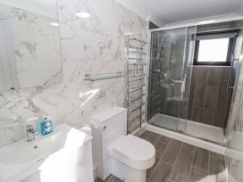 A bathroom with a shower and sink at Corner Cottage Broad Haven