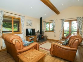 A living room with a sofa and television at Valley View Lodge in Welshpool