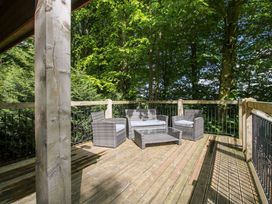An outdoor area with seating and trees at Valley View Lodge in Welshpool