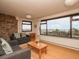A living room with a coffee table and view at Tregiffian Vean Sennen Cove