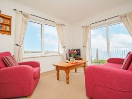 A living room with a sofa and a table at The Lookout in Sennen