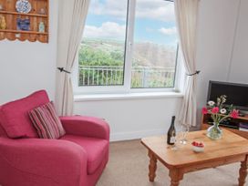 A living room with an armchair and a coffee table at The Lookout in Sennen