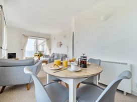 A living room with a table and chairs at The Lookout in Sennen