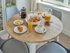 A dining room with a table set for breakfast at The Lookout in Sennen
