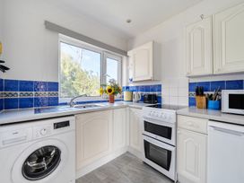 A kitchen with appliances and a window at The Lookout in Sennen