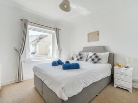 A bedroom with a bed and nightstand at The Lookout in Sennen