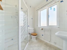 A bathroom with a shower and toilet at The Lookout in Sennen