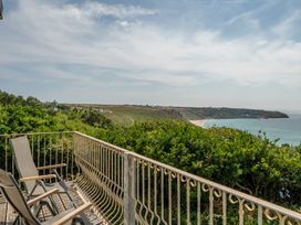 A balcony with chairs overlooking the ocean at The Lookout in Sennen