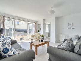 A living room with a sofa and chair at Brook House in Sennen Cove near St Just