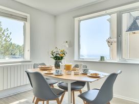 A dining room with a table set for breakfast at Brook House in Sennen Cove near St Just