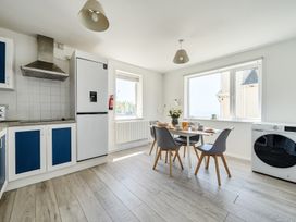 A kitchen with table and chairs at Brook House in Sennen Cove near St Just