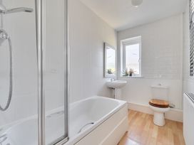 A bathroom with a bathtub and a sink at Brook House Sennen Cove near St Just
