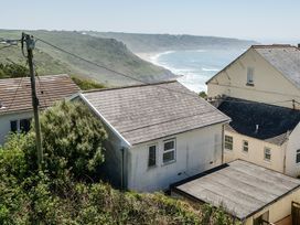 A view of houses and cliffs near the ocean at Brook House in Sennen Cove near St Just