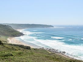 A beach view with waves and cliffs at Brook House Sennen Cove near St Just