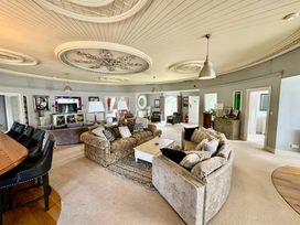 A living room with a sofa and coffee table at Capel Mawr Llanrug near Llanberis