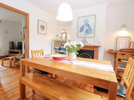 A dining room with a table and chairs at Driftwood Cottage Heacham