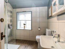 A bathroom with a shower, sink and toilet at Driftwood Cottage in Heacham