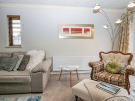 A living room with sofa and armchair at Kempton Bowness-on-Windermere