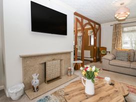 A living room with a TV mounted on the wall at Kempton in Bowness-on-Windermere