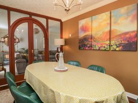 A dining room with a table and chairs at Kempton in Bowness-on-Windermere