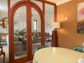 A dining room with a table and lamp at Kempton, Bowness-on-Windermere