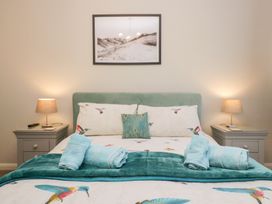 A bedroom with a bed and bedside tables at Kempton in Bowness-on-Windermere