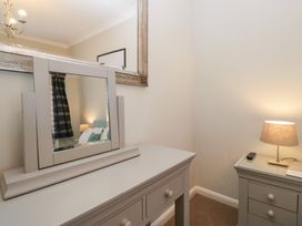 A bedroom with a vanity table and a lamp at Kempton in Bowness-on-Windermere