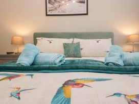A bedroom with a bed and pillows at Kempton in Bowness-on-Windermere