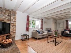 A living room with a television and coffee table at Wold Cottage in Hunmanby