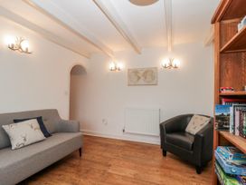 A living room with a sofa and armchair at Wold Cottage in Hunmanby