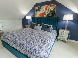 A bedroom with a bed and bedside tables at 1 The Old Smithy Cemaes Bay