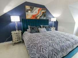 A bedroom with a bed and bedside tables at 1 The Old Smithy in Cemaes Bay