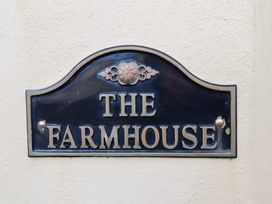 A sign reading The Farmhouse at The Farmhouse in Boggle Hole near Robin Hood's Bay