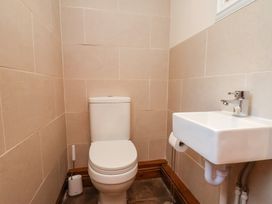 A bathroom with a toilet and sink at The Farmhouse in Boggle Hole near Robin Hood's Bay