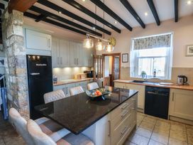 A kitchen with a refrigerator and countertop at The Farmhouse in Boggle Hole near Robin Hood's Bay