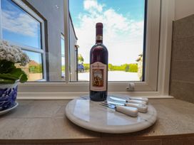 A bottle of wine and cutlery on a marble platter at The Farmhouse Boggle Hole near Robin Hood's Bay