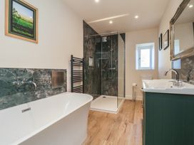 A bathroom with a shower and bathtub at The Farmhouse in Boggle Hole near Robin Hood's Bay