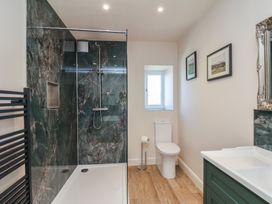 A bathroom featuring a shower, toilet and sink at The Farmhouse in Boggle Hole near Robin Hood's Bay