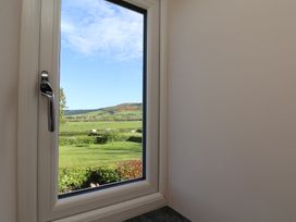 A window overlooking a grassy landscape at The Farmhouse in Boggle Hole near Robin Hood's Bay