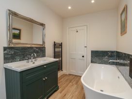 A bathroom with a bathtub and sink at The Farmhouse in Boggle Hole near Robin Hood's Bay